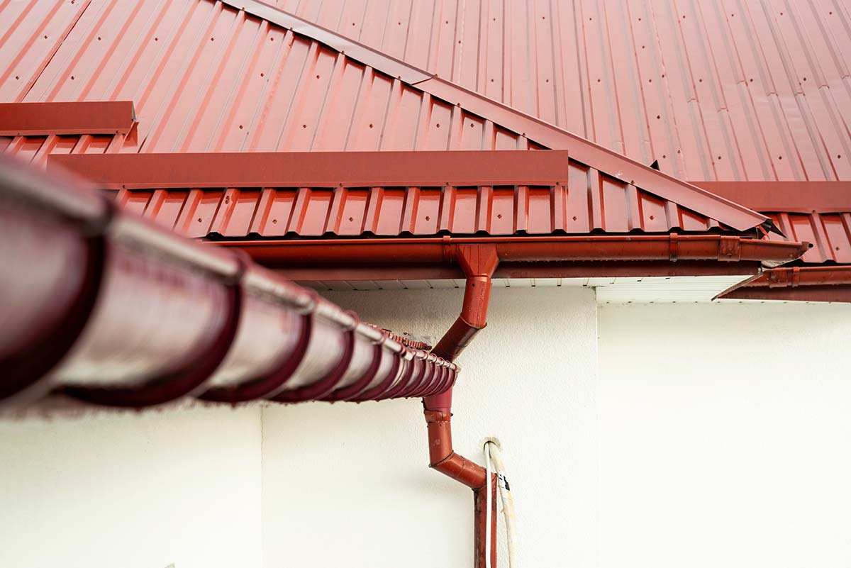 Example of a gutter installed on a red-roofed house, designed to prevent overflowing gutters.